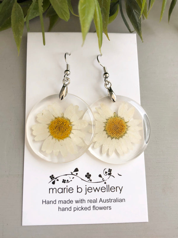 Earrings made with real daisies set in resin